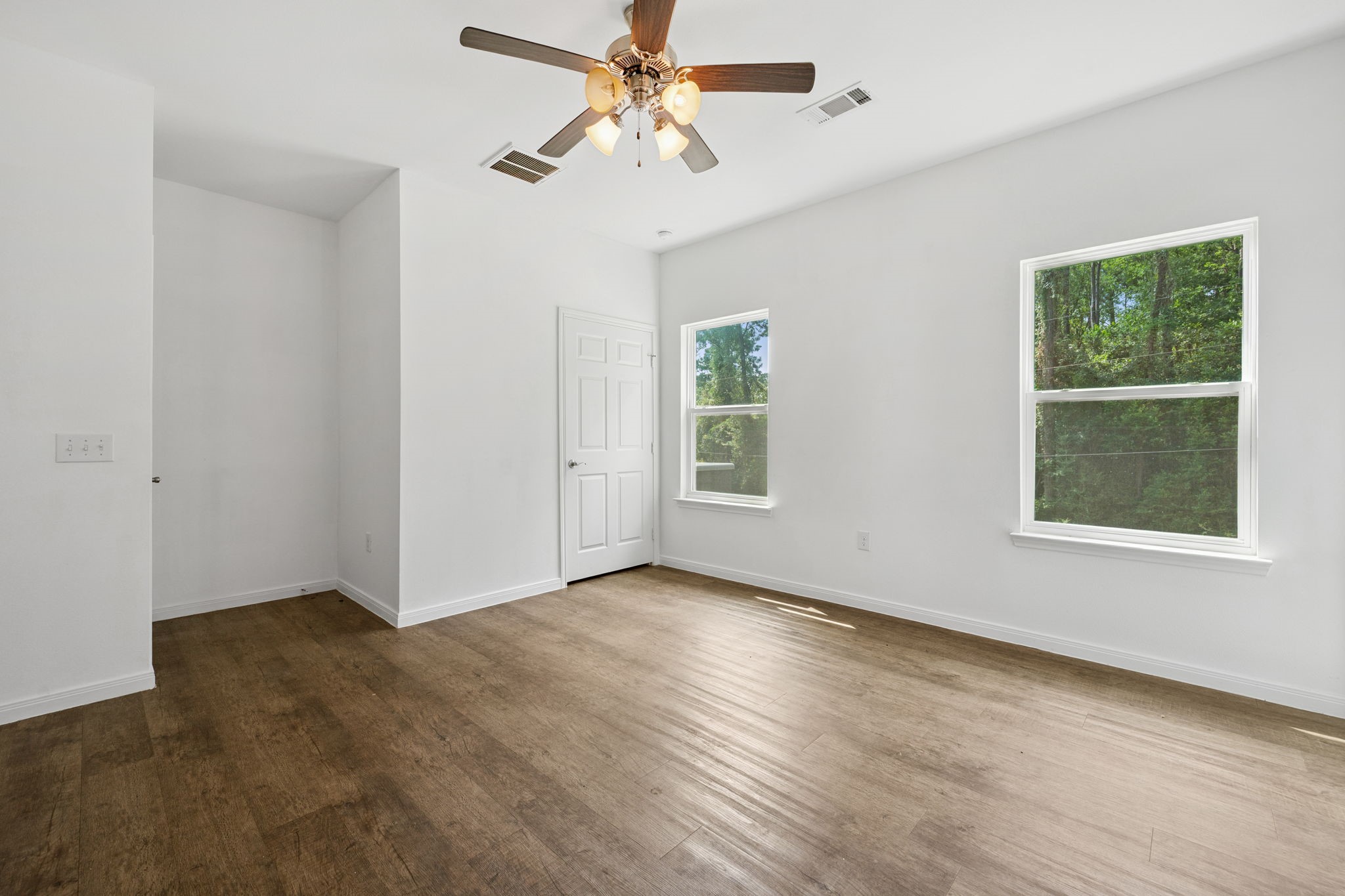 325 Cemetery Road Coldspring, TX 77331 - Photo 15 of 31 an empty room with windows and fan