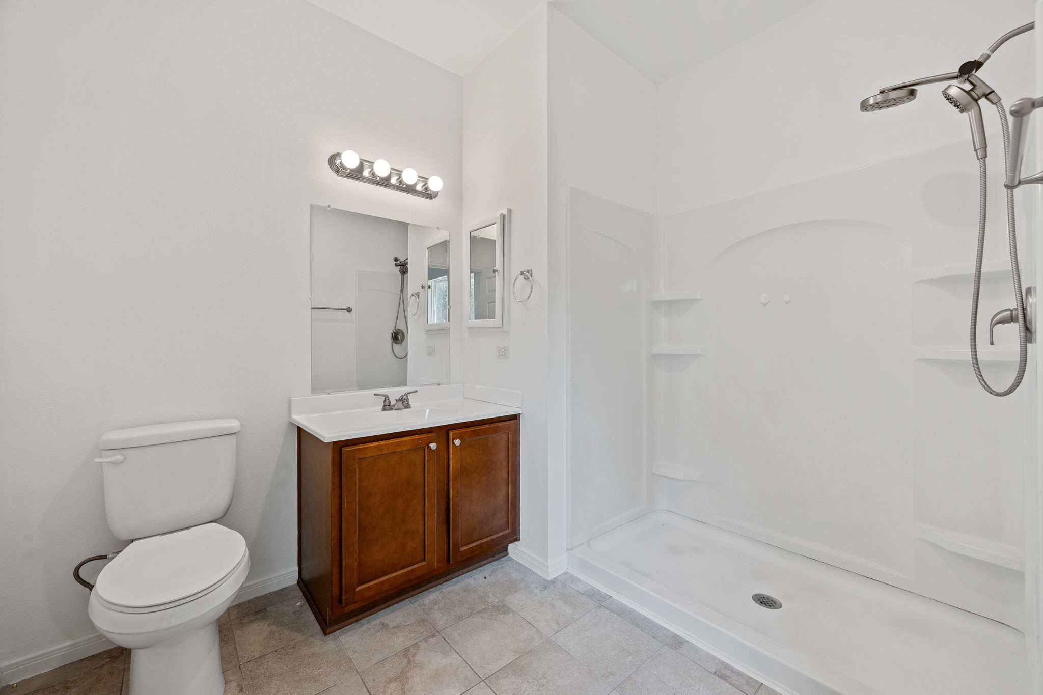 325 Cemetery Road Coldspring, TX 77331 - Photo 17 of 31 a bathroom with a granite countertop sink a toilet and a shower