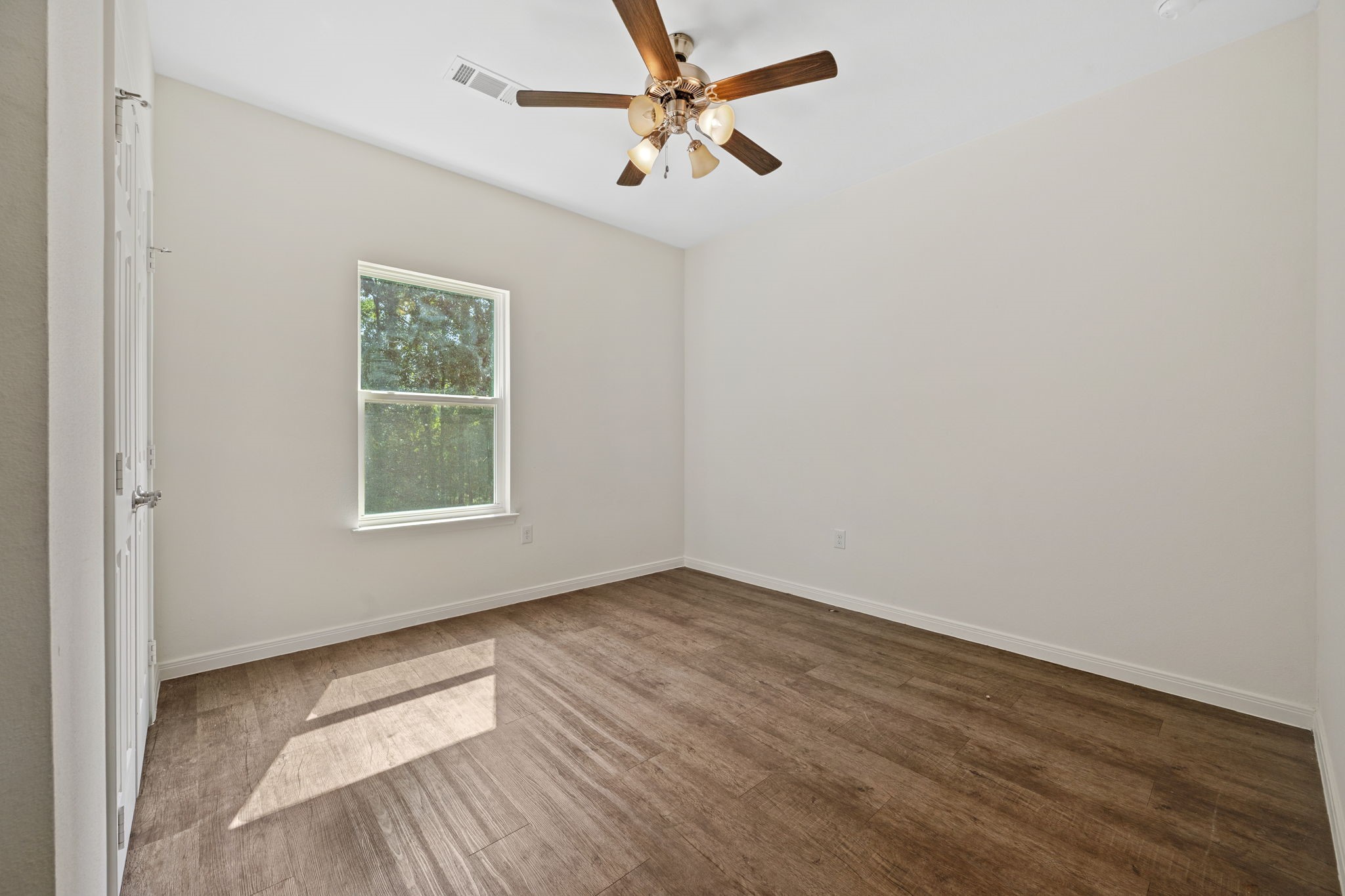 325 Cemetery Road Coldspring, TX 77331 - Photo 18 of 31 an empty room with windows and fan