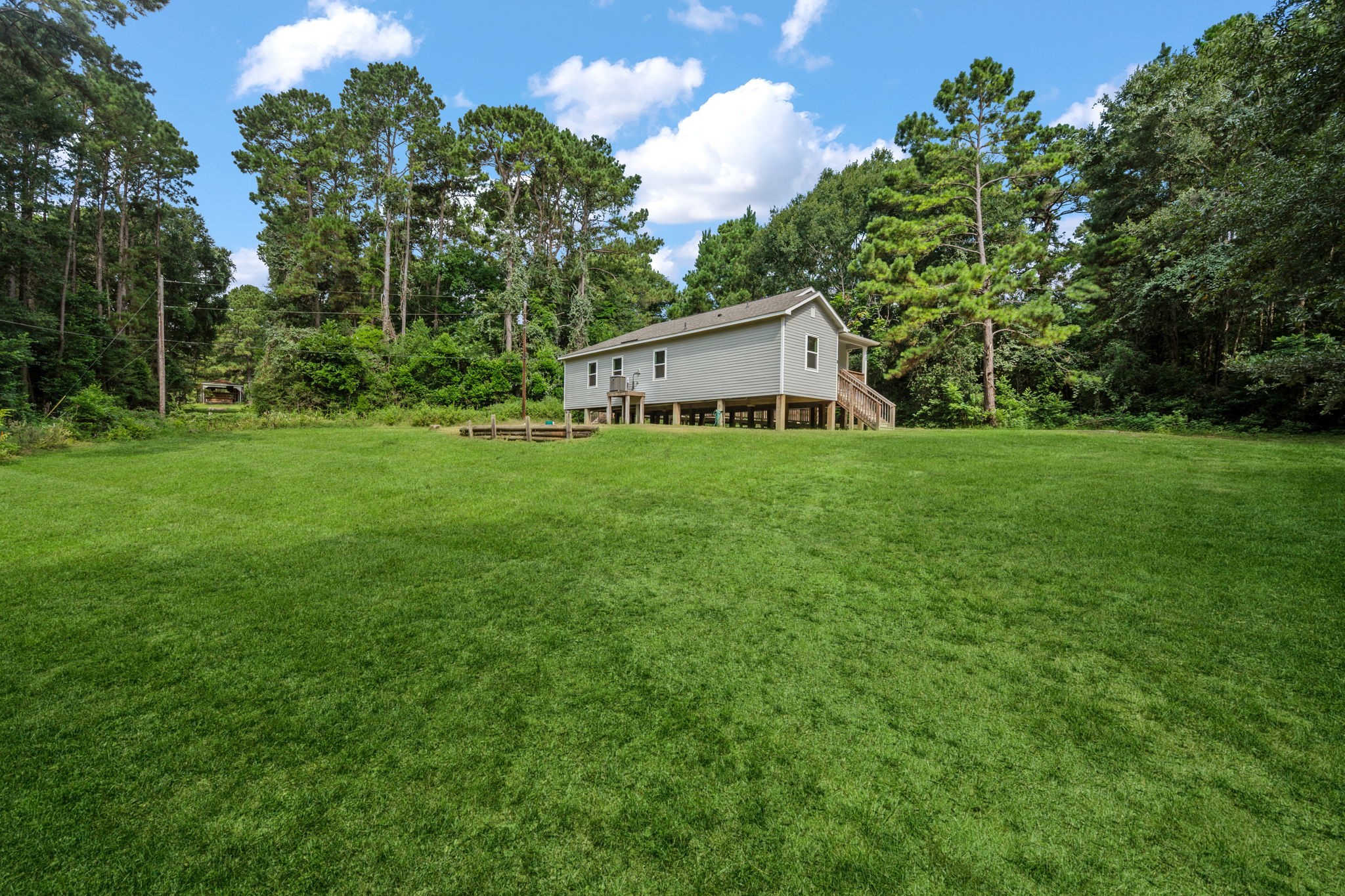 325 Cemetery Road Coldspring, TX 77331 - Photo 25 of 31 a house with green field in front of it