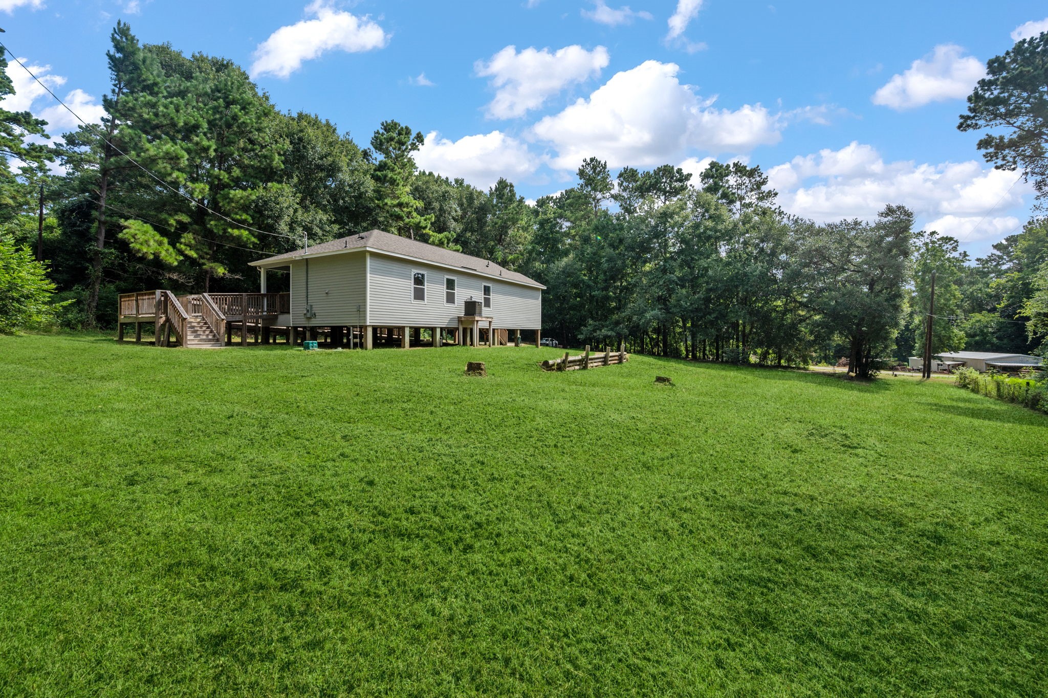 325 Cemetery Road Coldspring, TX 77331 - Photo 26 of 31 a white house with a big yard and large trees