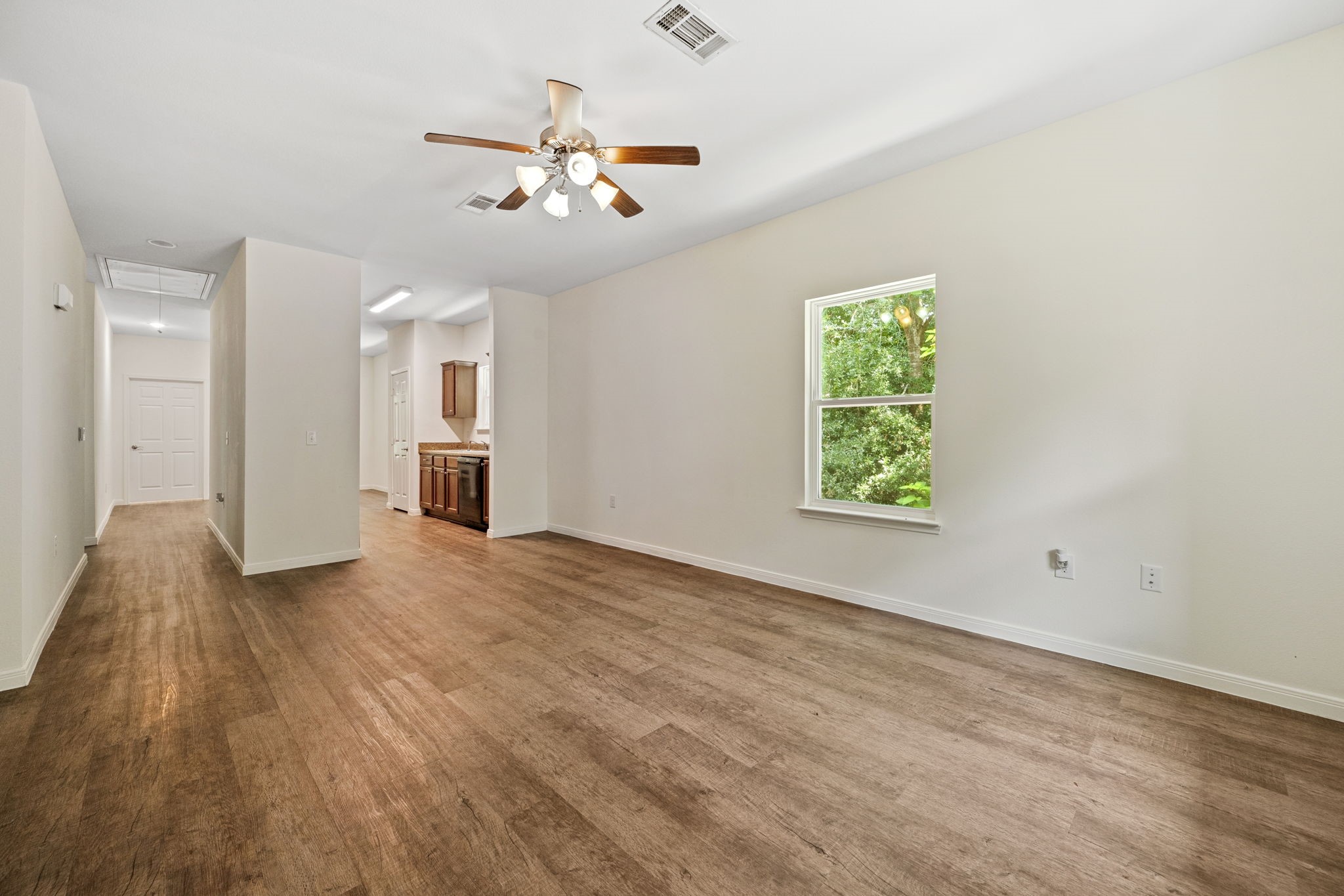 325 Cemetery Road Coldspring, TX 77331 - Photo 6 of 31 wooden floor in an empty room with a window