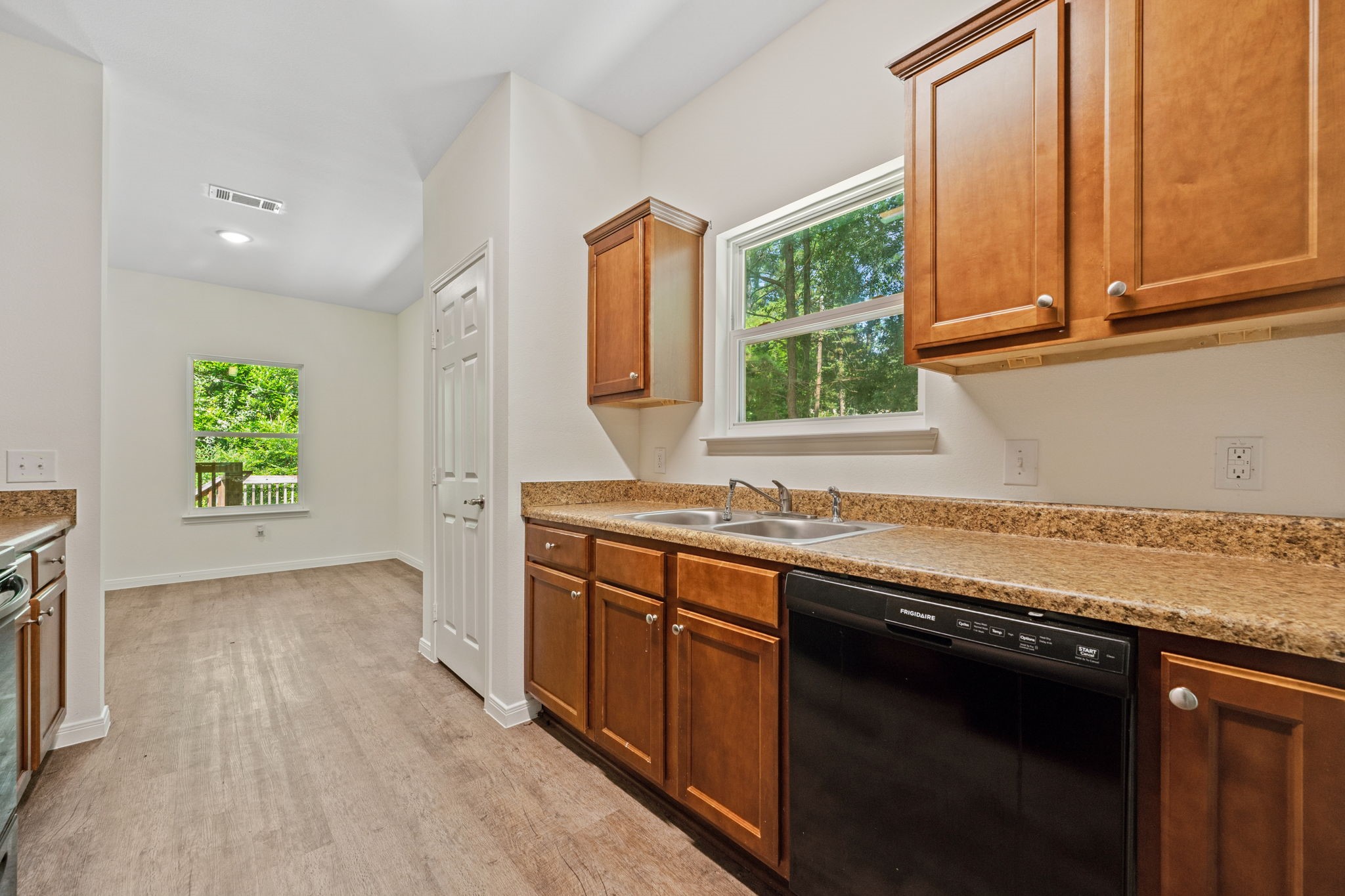 325 Cemetery Road Coldspring, TX 77331 - Photo 9 of 31 a kitchen with stainless steel appliances granite countertop a stove a sink and a microwave