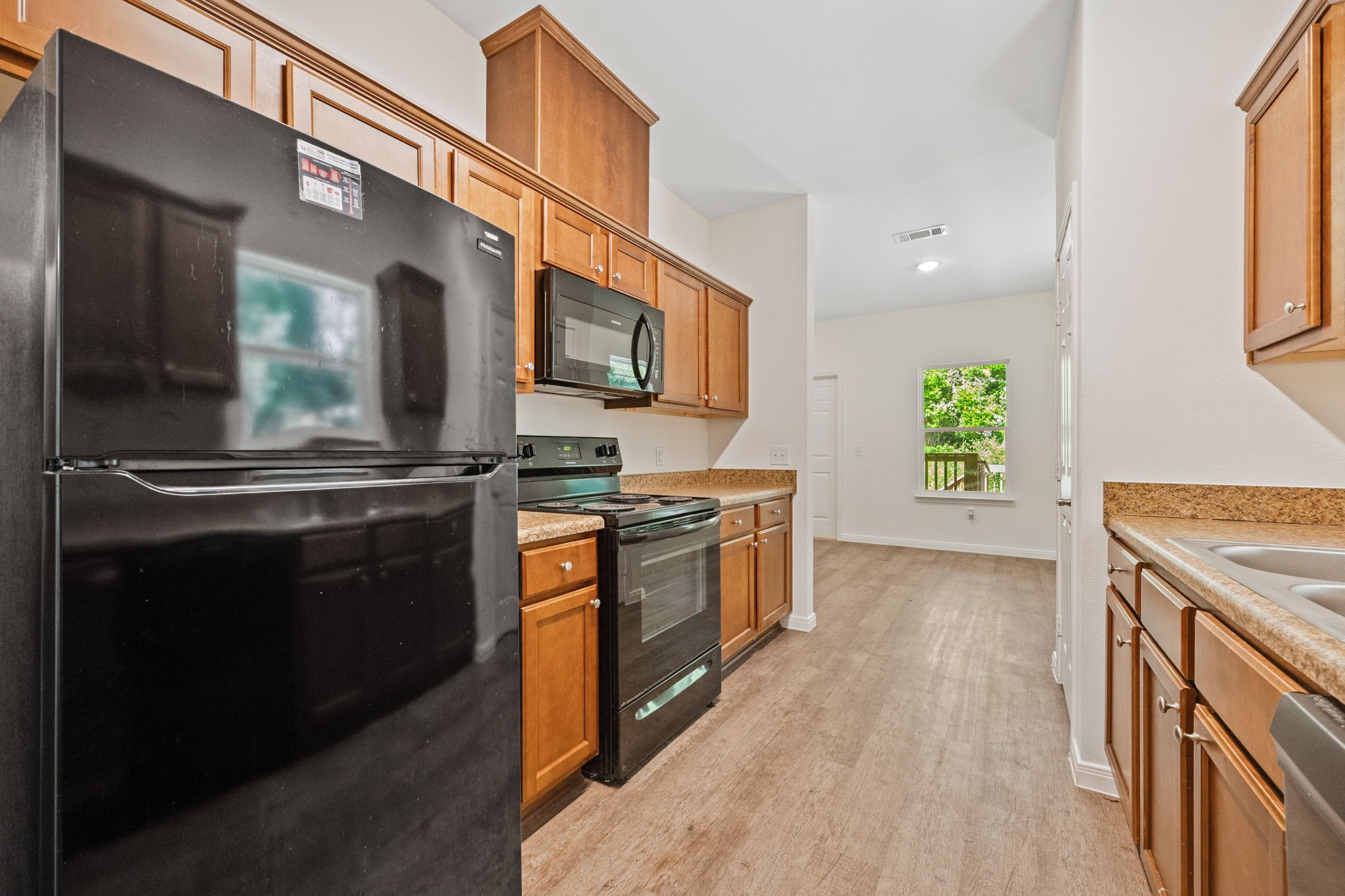 325 Cemetery Road Coldspring, TX 77331 - Photo 10 of 31 a kitchen with stainless steel appliances kitchen island granite countertop a stove a sink and a microwave