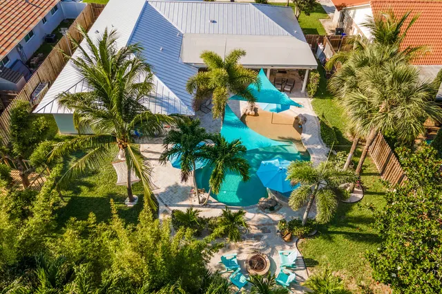an aerial view of a house with a yard and garden