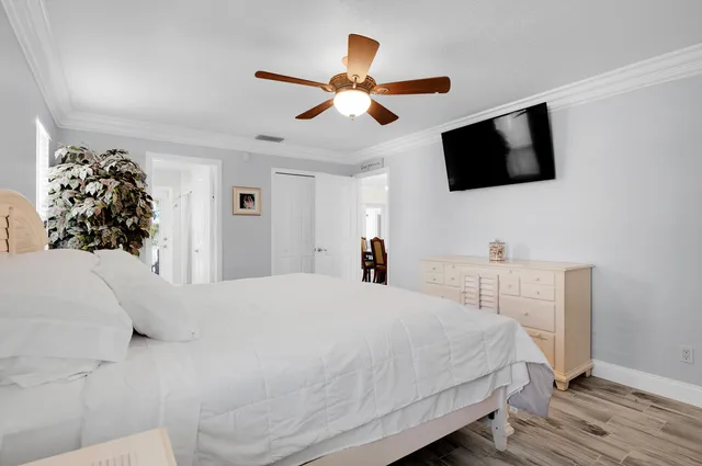 a spacious bedroom with a bed and a chandelier