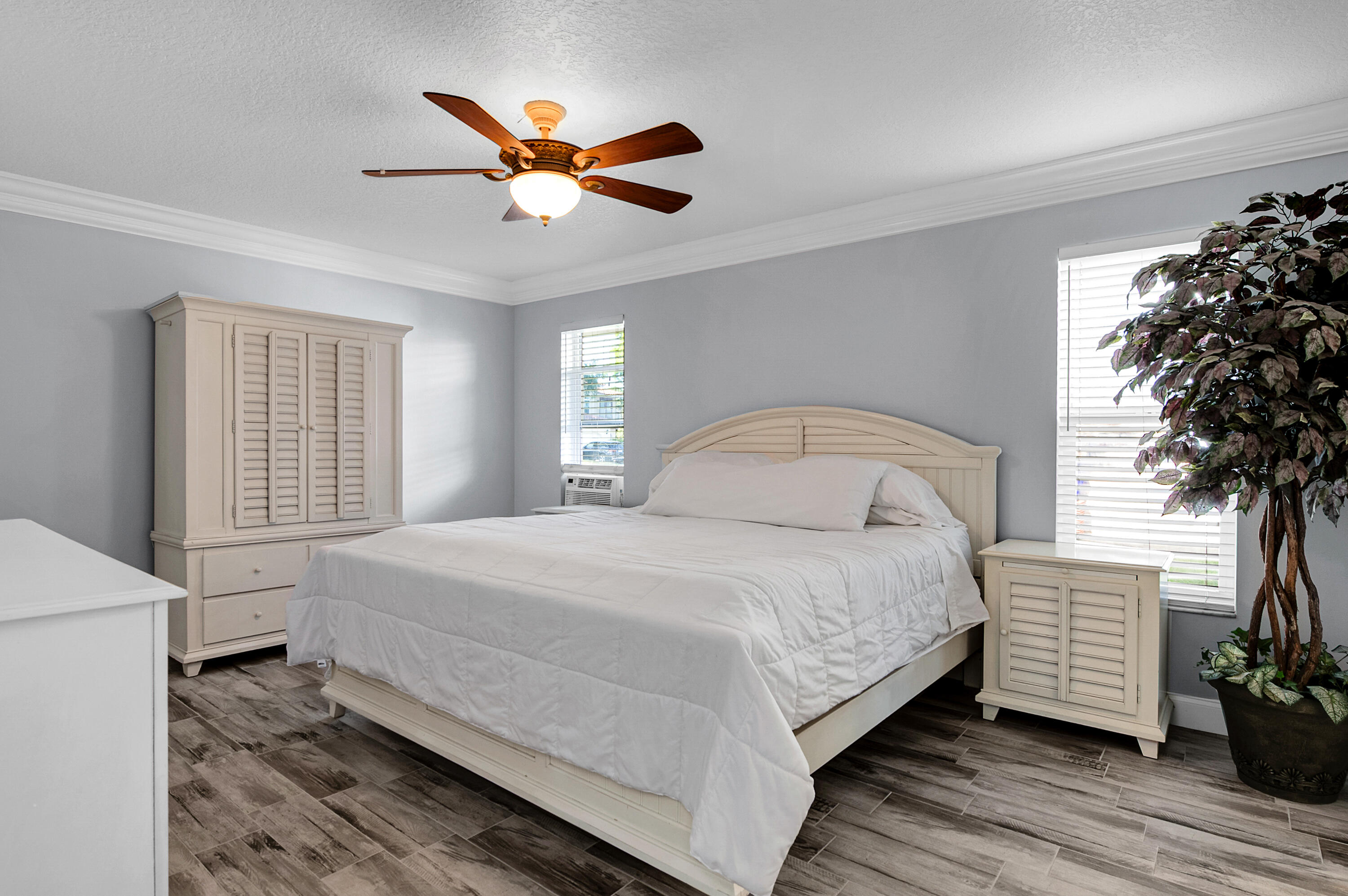 1560 Southwest 16th Street Boca Raton, FL 33486 - Photo 21 of 72 a bedroom with a bed and a potted plant