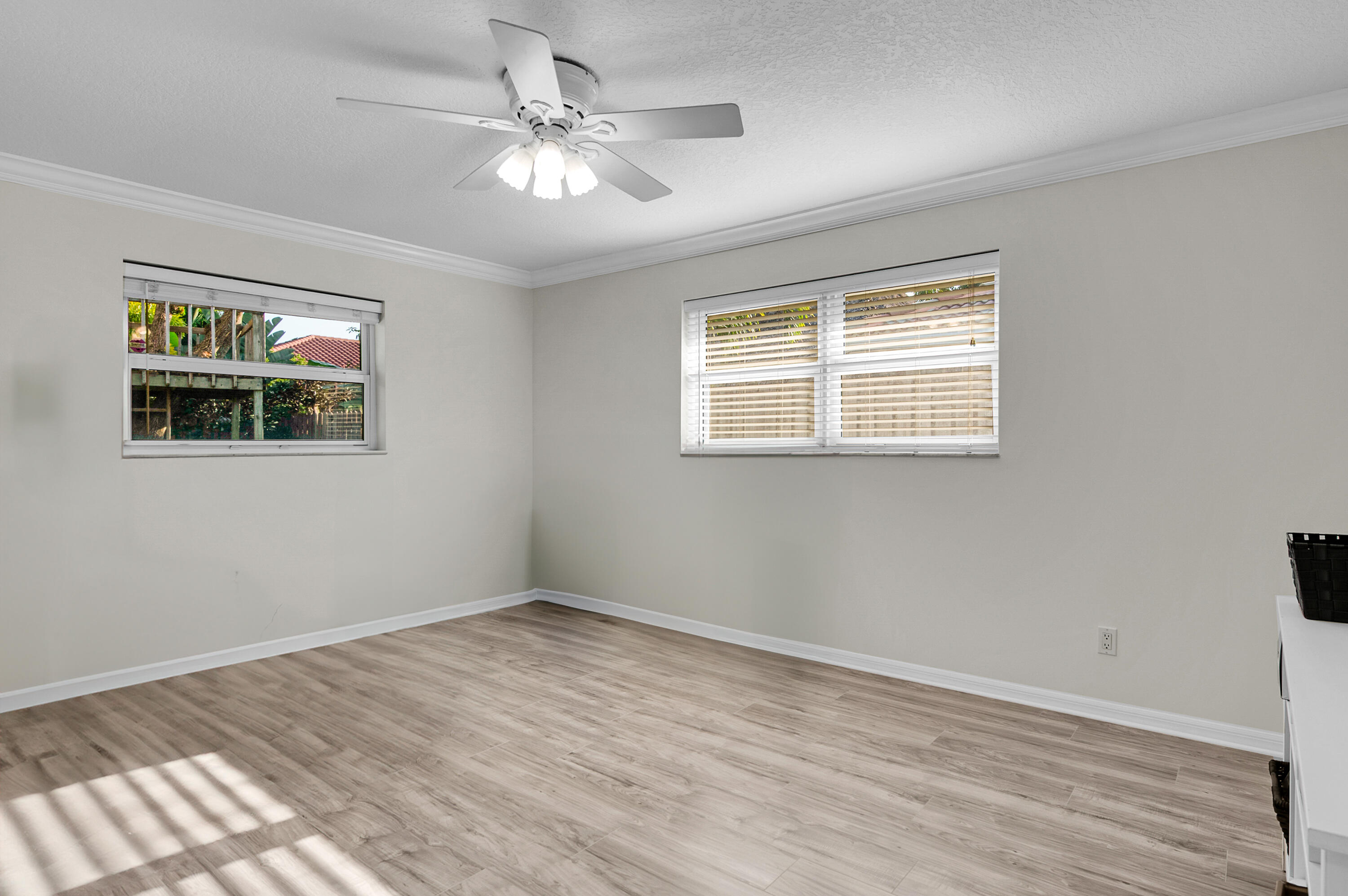 1560 Southwest 16th Street Boca Raton, FL 33486 - Photo 28 of 72 a view of an empty room with wooden floor and a window