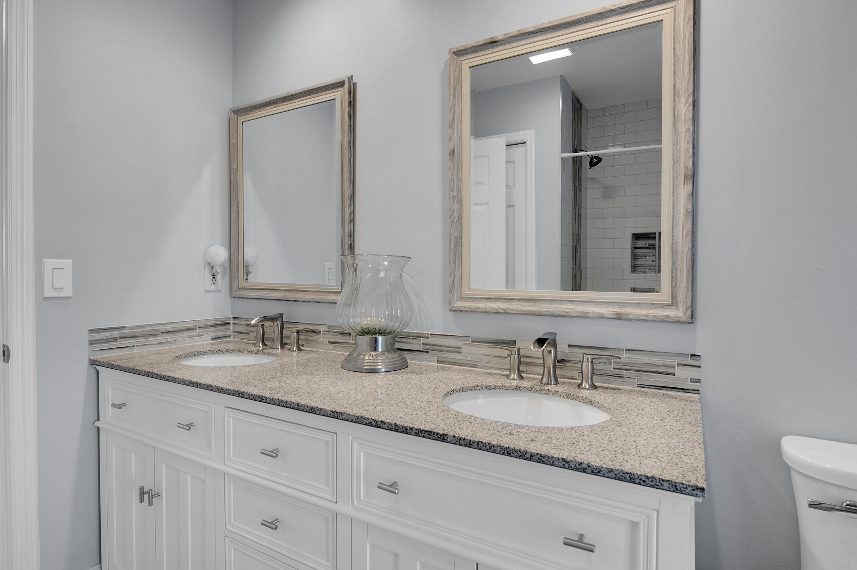 1560 Southwest 16th Street Boca Raton, FL 33486 - Photo 33 of 72 a bathroom with a granite countertop double sink and a mirror