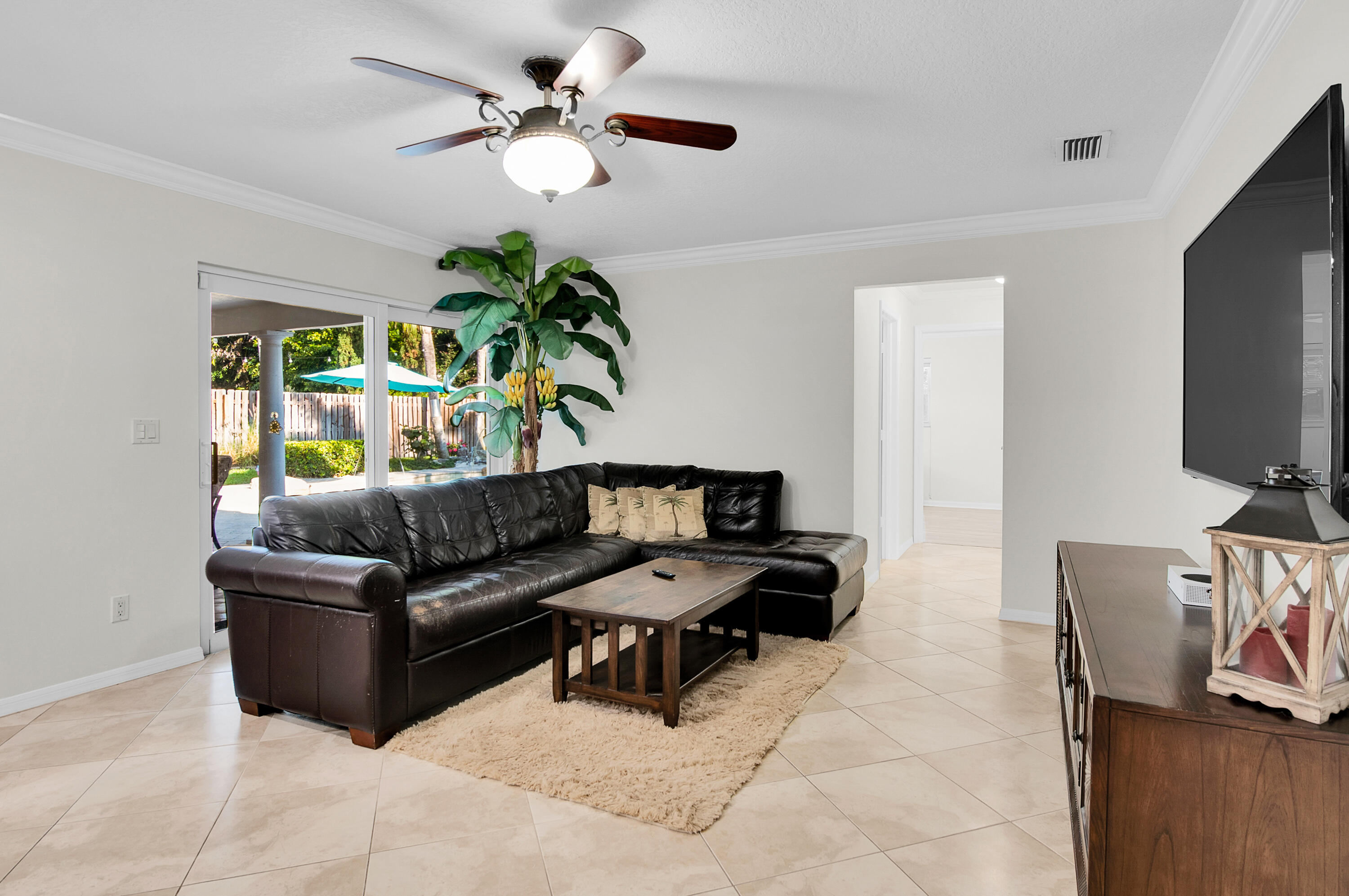 1560 Southwest 16th Street Boca Raton, FL 33486 - Photo 38 of 72 a living room with furniture and a flat screen tv