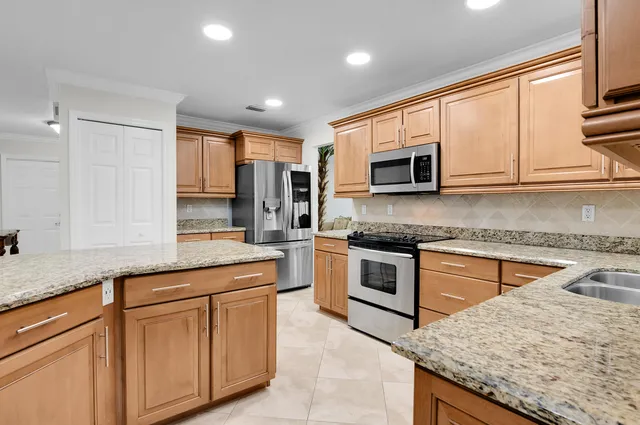 a dining room with furniture and a floor to ceiling window