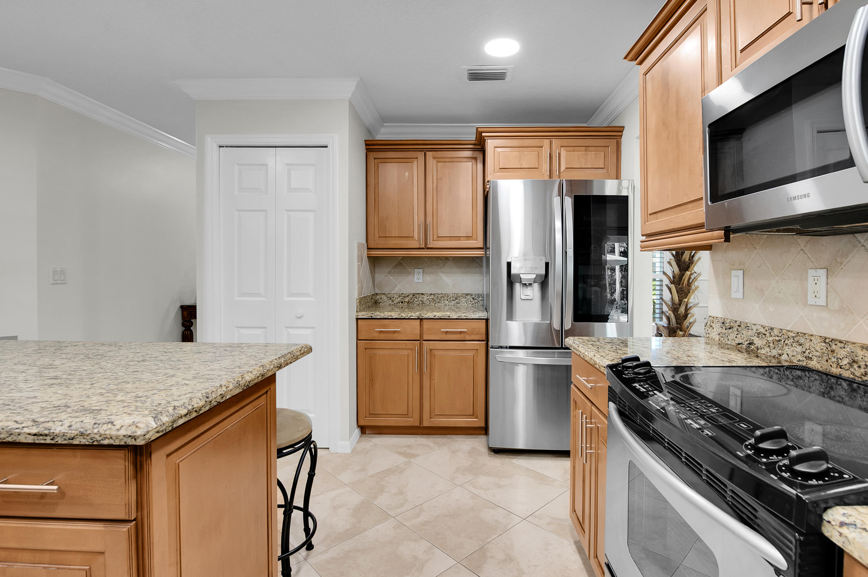 1560 Southwest 16th Street Boca Raton, FL 33486 - Photo 40 of 72 a kitchen with a stove and a refrigerator