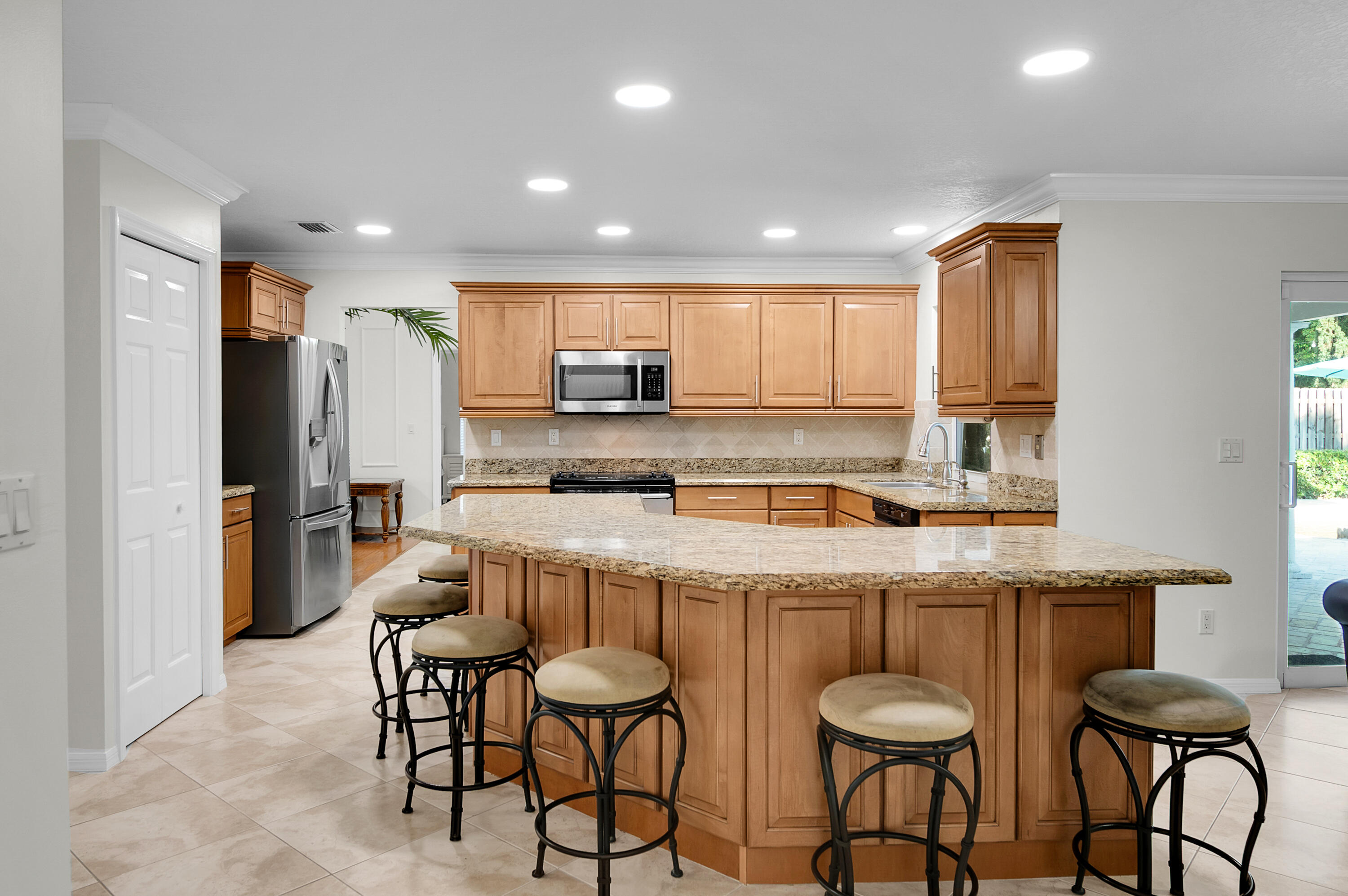 1560 Southwest 16th Street Boca Raton, FL 33486 - Photo 44 of 72 a kitchen with stainless steel appliances granite countertop a sink and a refrigerator