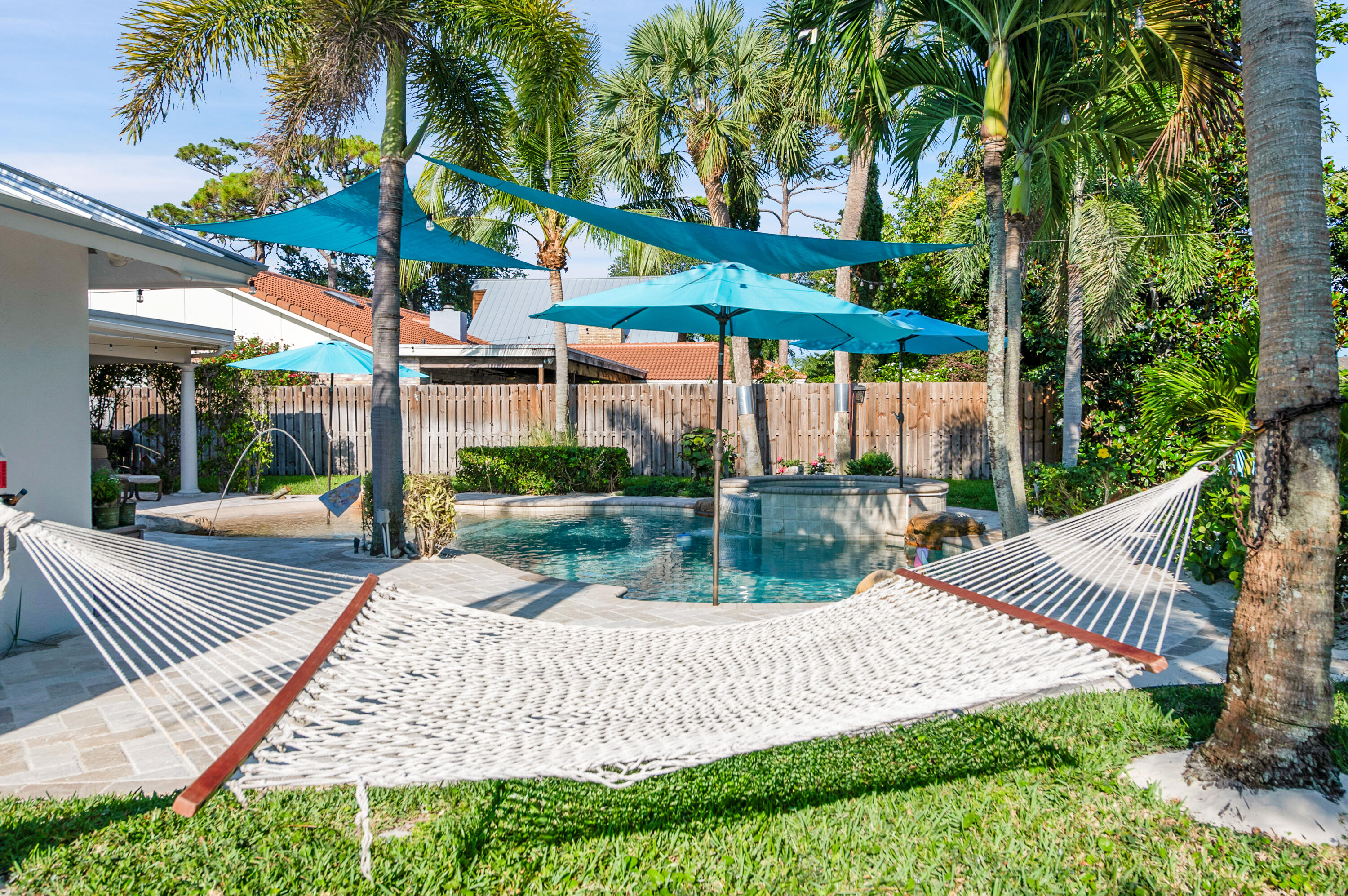 1560 Southwest 16th Street Boca Raton, FL 33486 - Photo 55 of 72 a view of a patio with a table chairs and a slide