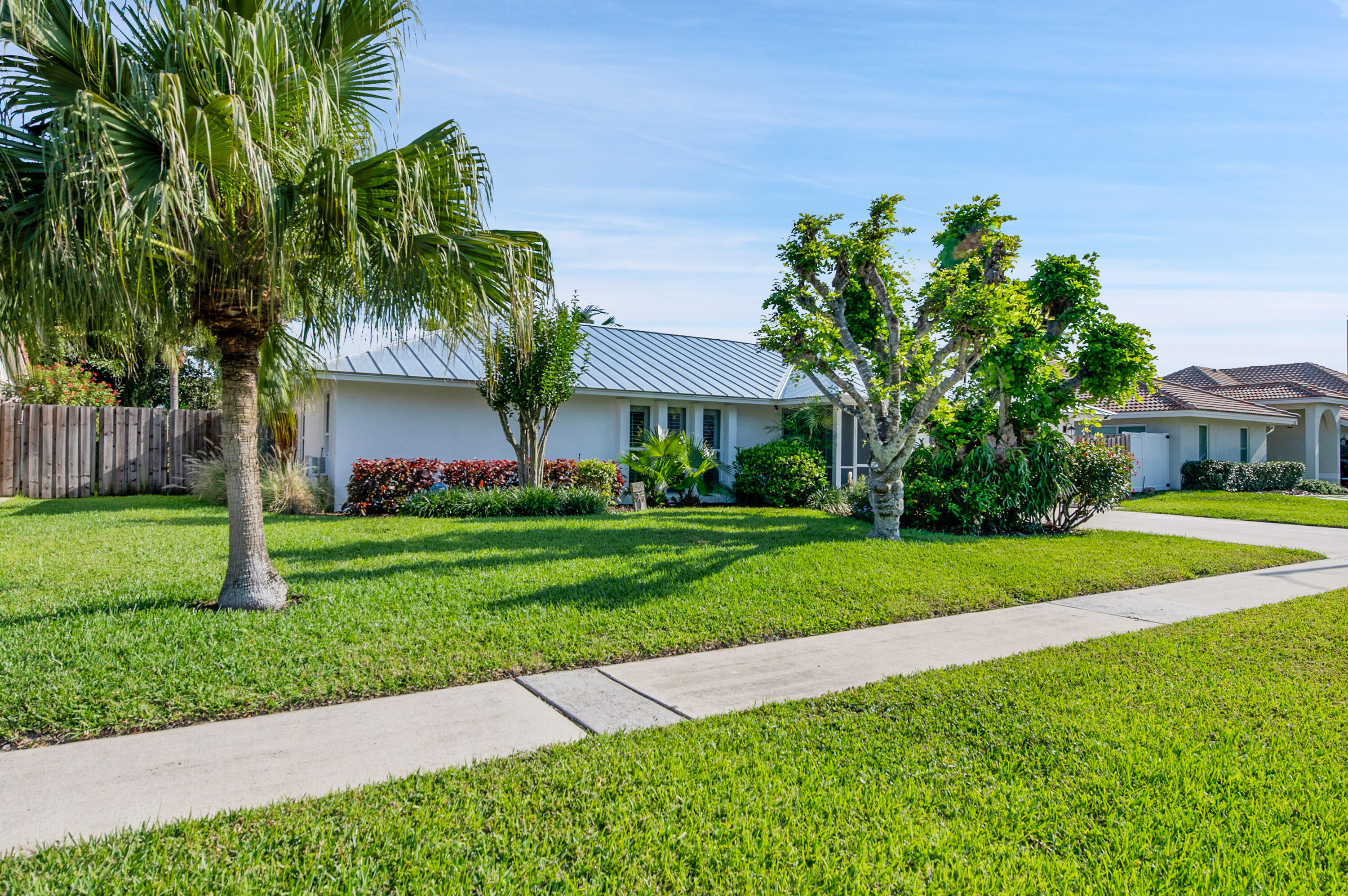 1560 Southwest 16th Street Boca Raton, FL 33486 - Photo 9 of 72 a front view of a house with a yard and fountain