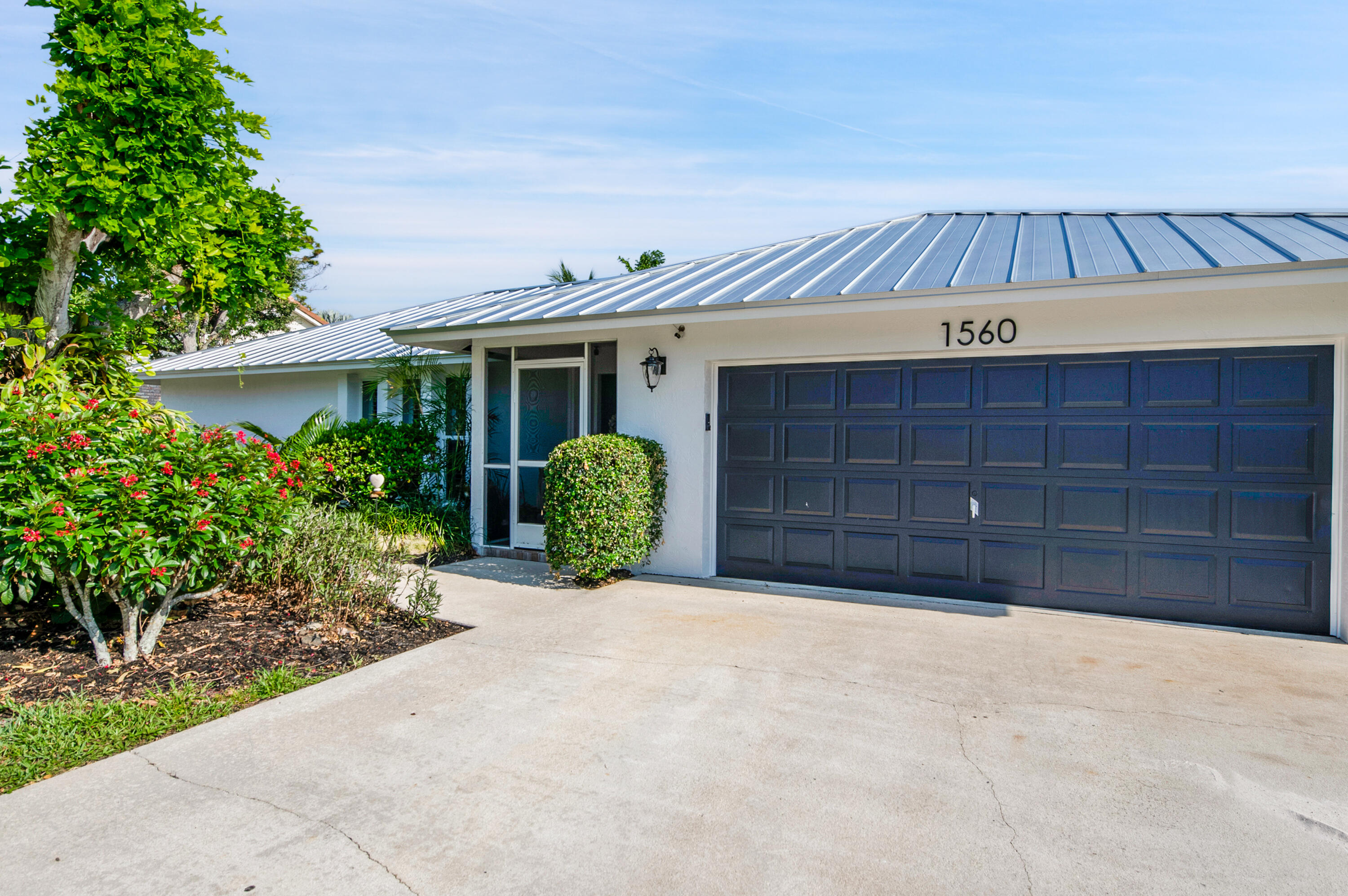 1560 Southwest 16th Street Boca Raton, FL 33486 - Photo 10 of 72 a view of a house with a yard and potted plants