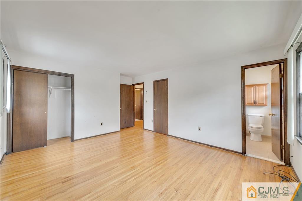 65 Dellwood Road Edison, NJ 08820 - Photo 15 of 24 a view of an empty room with wooden floor and a window