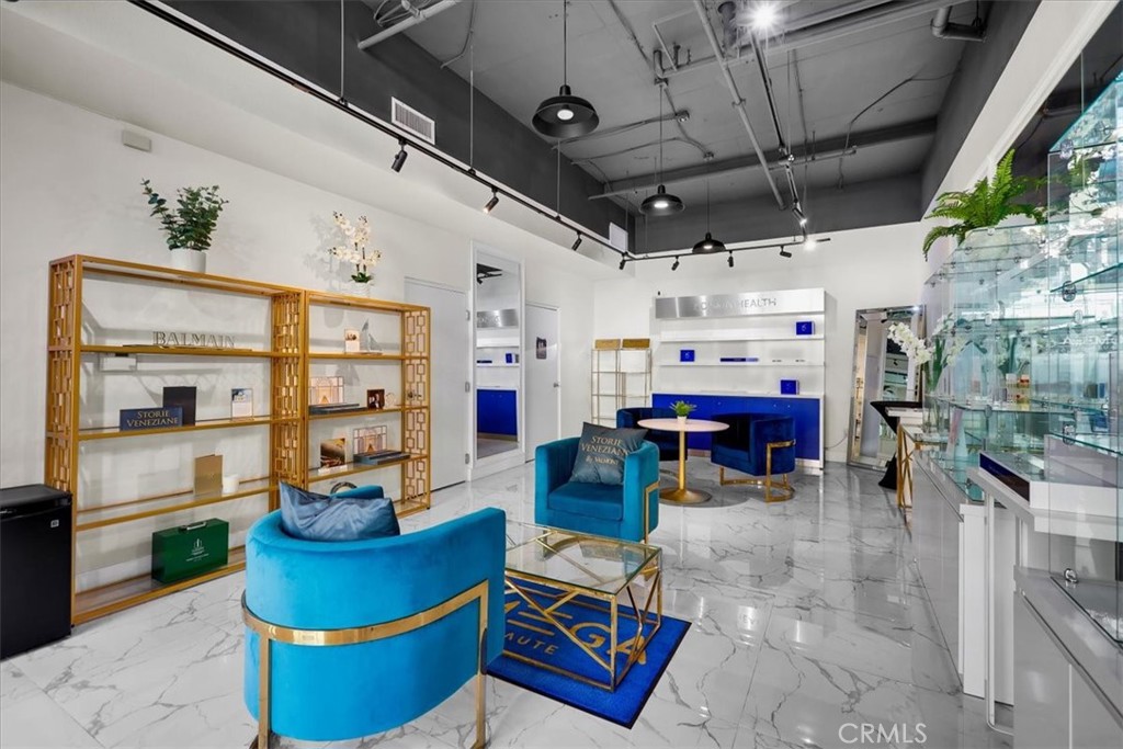 300 East 4th Street, Unit 103 Long Beach, CA 90802 - Photo 13 of 75 a living room with furniture and a chandelier