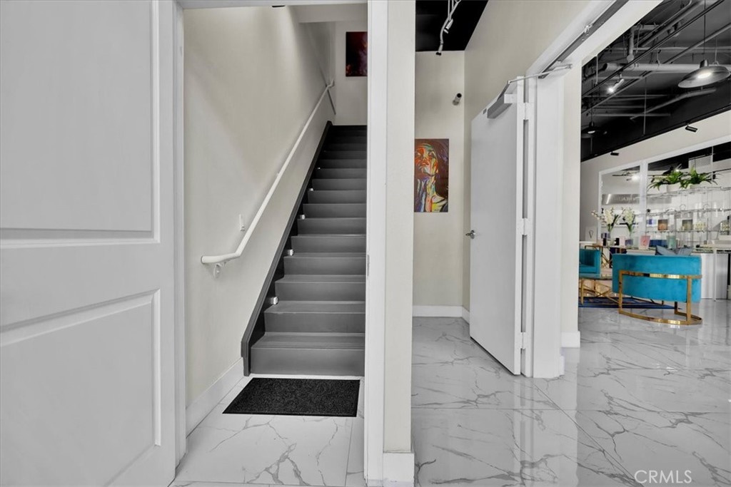 300 East 4th Street, Unit 103 Long Beach, CA 90802 - Photo 31 of 75 a view of a hallway to a livingroom with wooden floor and entryway