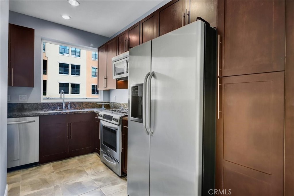 300 East 4th Street, Unit 103 Long Beach, CA 90802 - Photo 38 of 75 a kitchen with stainless steel appliances granite countertop a refrigerator and a sink
