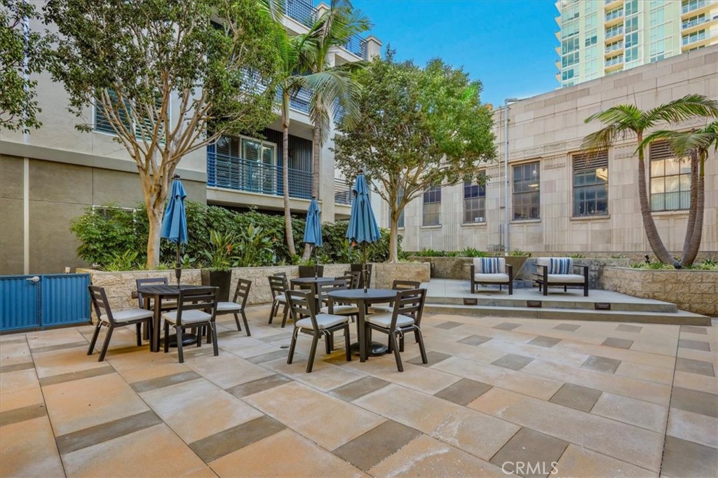 300 East 4th Street, Unit 103 Long Beach, CA 90802 - Photo 68 of 75 a view of a patio with table and chairs and potted plants