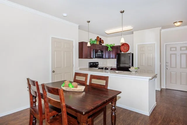 a view of a dining room with furniture and wooden floor