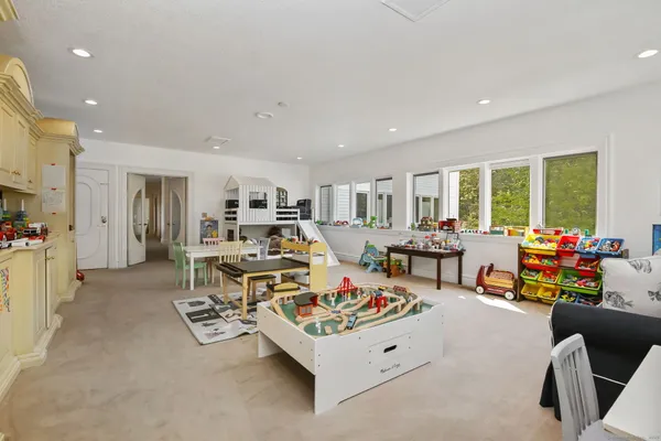 a living room with furniture and a dining table with kitchen view