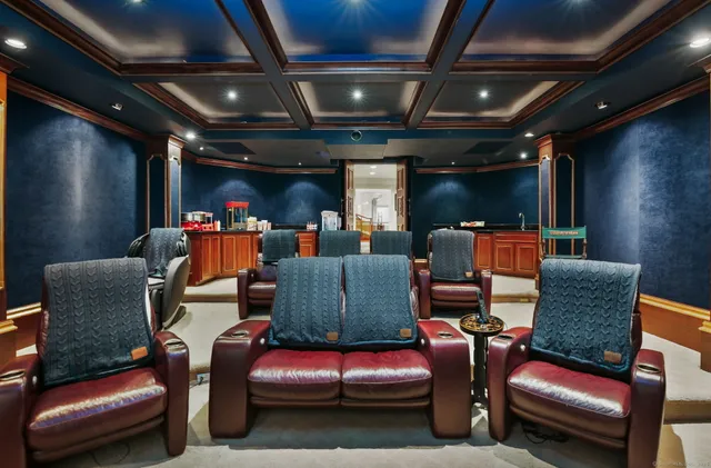 a living room with furniture a flat screen tv and a glass table