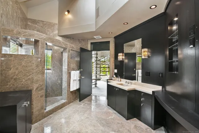 a spacious bathroom with a tub sink and mirror