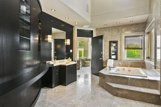 a bedroom with furniture and a large window