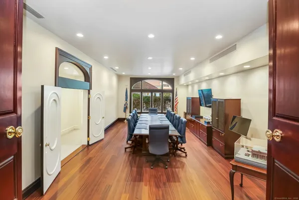 a living room with furniture a flat screen tv and a glass table