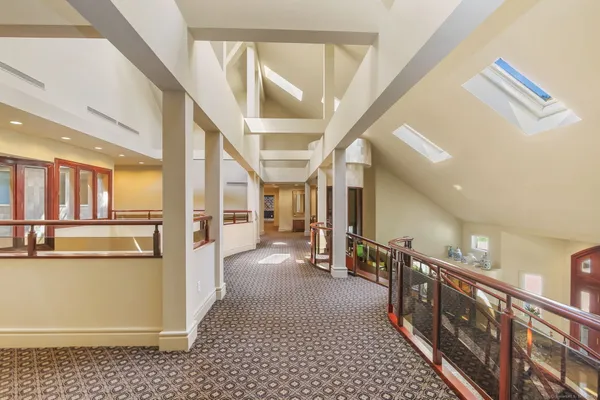 a bedroom with a large bed and windows