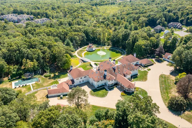 an aerial view of a house with yard swimming pool and outdoor seating