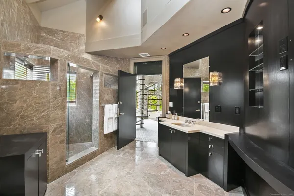 a bedroom with furniture and a large window