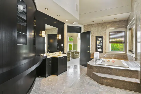 a large bathroom with a sink a large mirror and shower