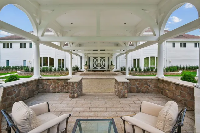 a view of a patio with a table and chairs