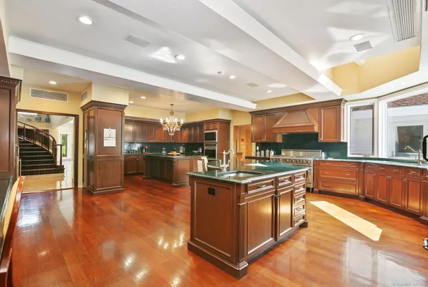 a kitchen with stainless steel appliances granite countertop a stove and a refrigerator