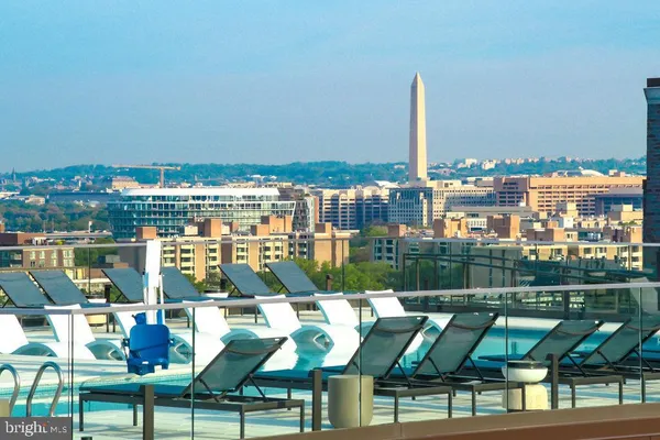 a view of a patio with couches table and chairs and potted plants