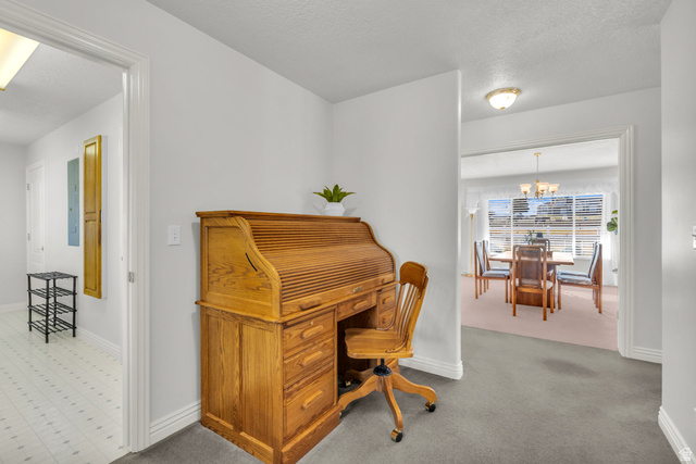 1060 West 2620th Street South Mapleton, UT 84664 - Photo 50 of 87 Office area with a textured ceiling, hanging lights, light colored carpet, and electric panel