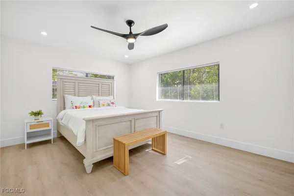 a bedroom with a bed a dresser and a window