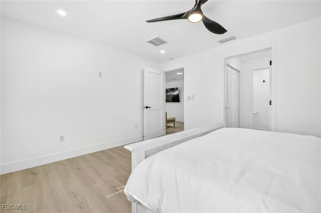 a large white bed in a white room