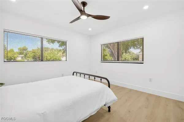 a bedroom with a large bed and a window
