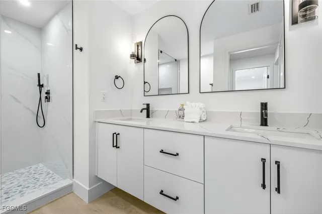 a bathroom with a double vanity sink and mirror