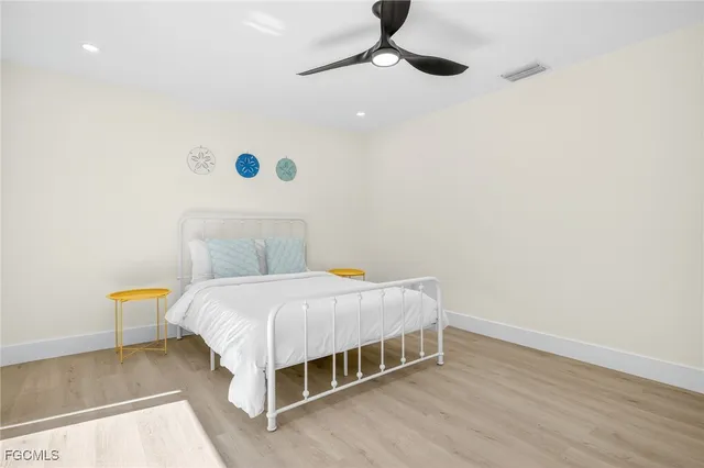 a bedroom with a bed and wooden floor