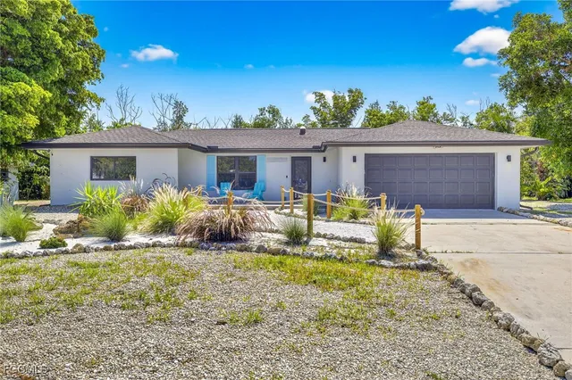 a view of a house with backyard and sitting area