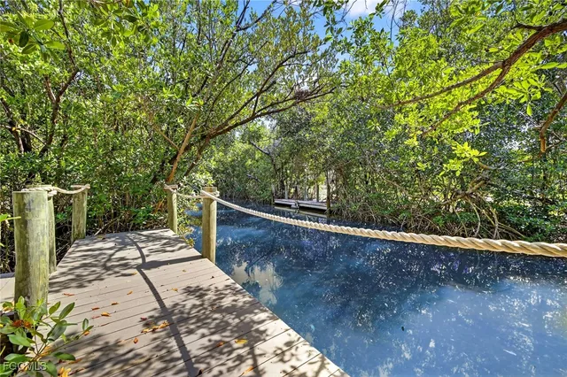 a view of a backyard with wooden fence