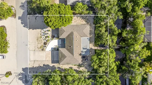 an aerial view of a house with a yard