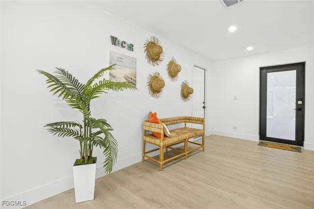 wooden floor with a potted plant and a sign