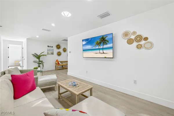 a living room with furniture and a wooden floor