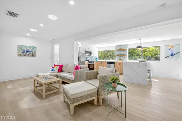 a living room with furniture and wooden floor